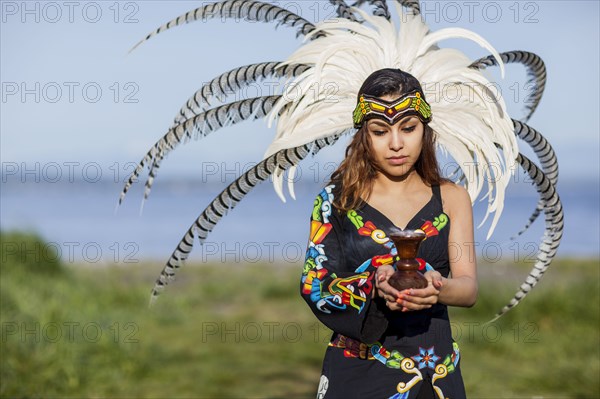 Native American woman in traditional headdress performing ceremony