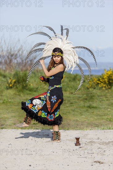 Native American woman in traditional headdress performing ceremony