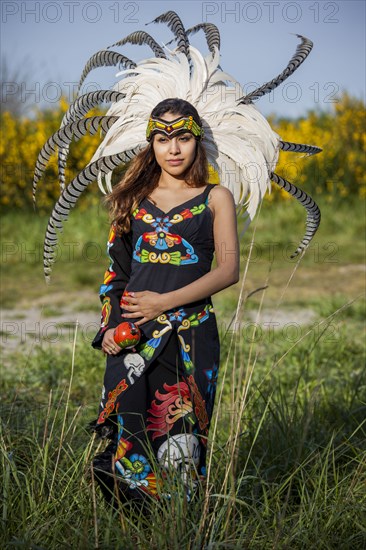 Native American woman in traditional headdress performing ceremony