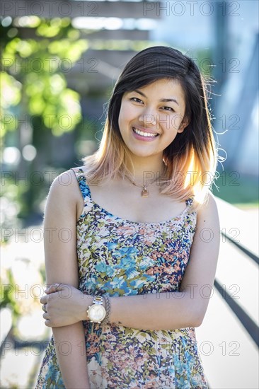 Portrait of smiling Chinese woman wearing dress