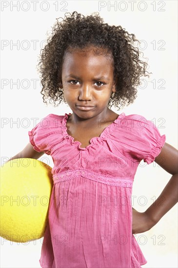 Studio shot of African girl holding ball