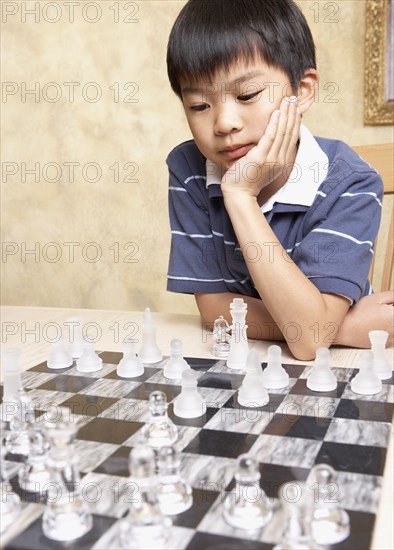 Asian boy playing chess