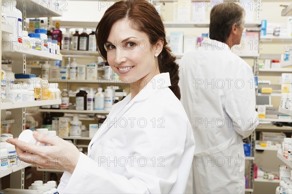 Female and male pharmacists in pharmacy