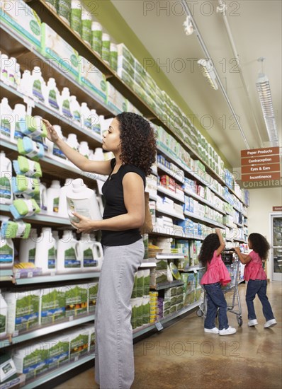 Mother with young daughters in grocery store