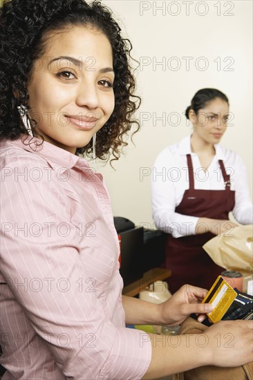 Woman holding credit card at checkout