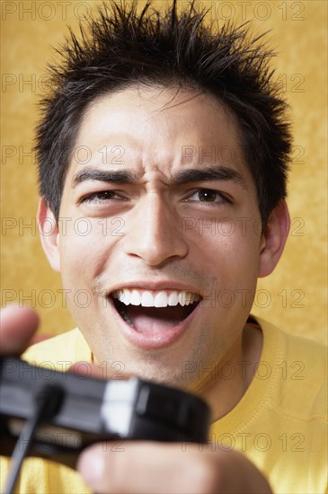 Close up Hispanic man playing video games