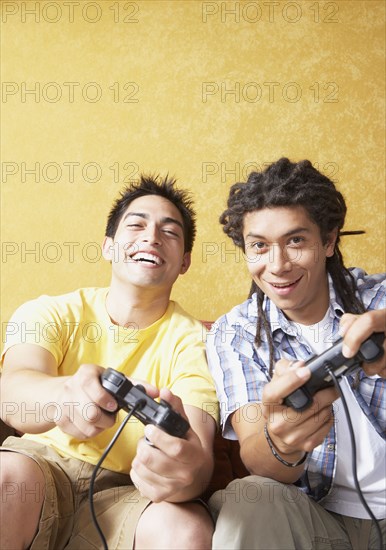 Two Hispanic men playing video games