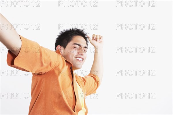 Studio shot of Hispanic man dancing