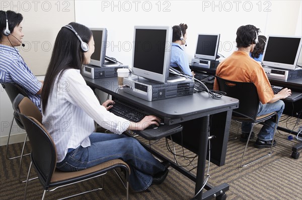 Young computer service technicians with headsets