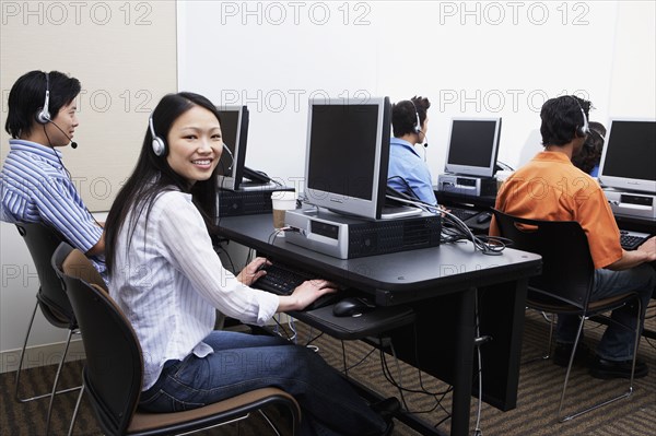 Young computer service technicians with headsets