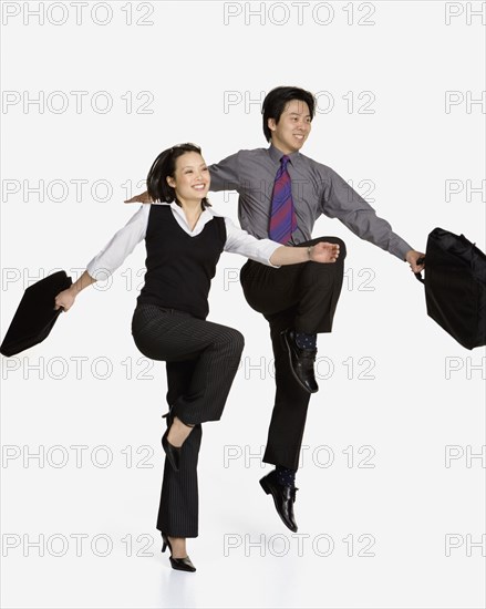 Studio shot of Asian businesspeople skipping