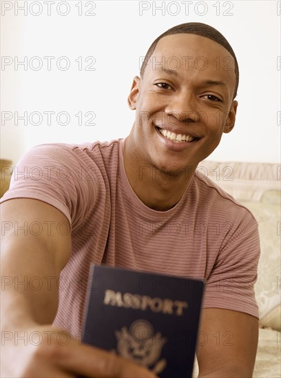 African man holding out passport