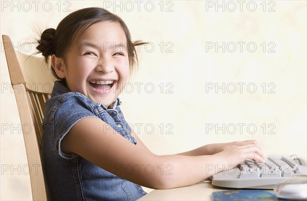 Young Asian girl using computer