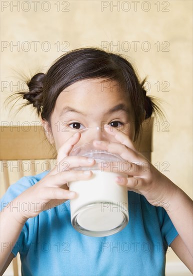 Young Asian girl drinking milk