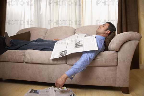 Hispanic man sleeping on sofa