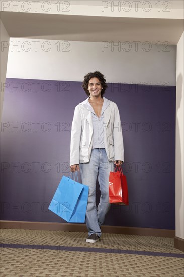 Hispanic man carrying shopping bags