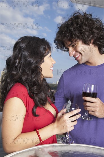 Hispanic couple smiling at each other