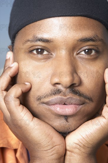 Close up of African man with chin in hands