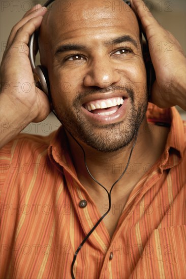 Mixed Race man listening to headphones