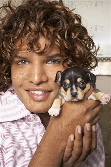 Middle Eastern man holding puppy