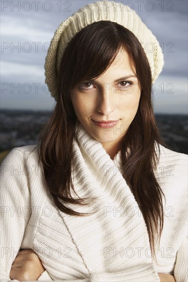 Hispanic woman wearing hat and sweater