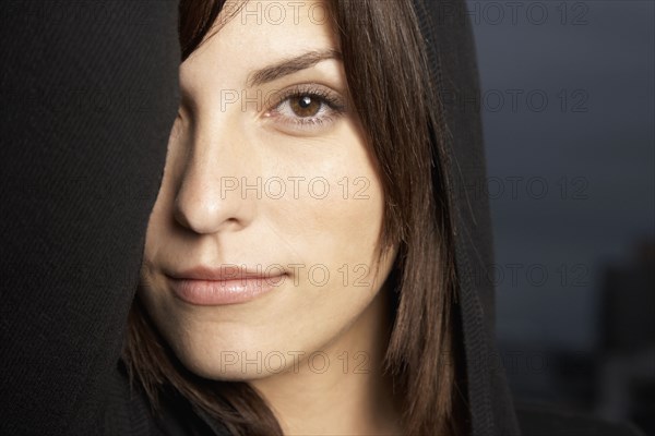 Hispanic woman with arm over eye