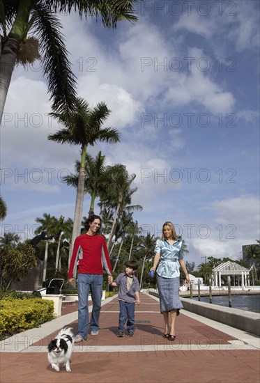 Hispanic family walking dog