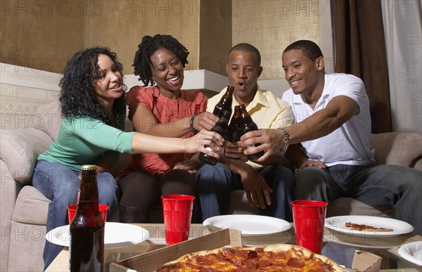 Multi-ethnic friends having pizza party