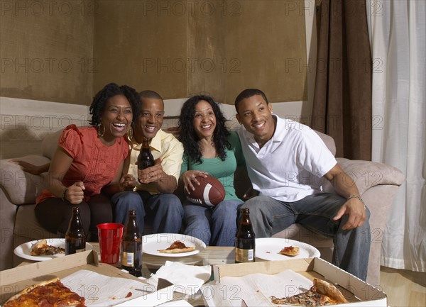 Multi-ethnic friends watching sports on television