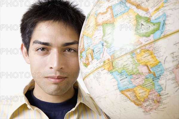 Pacific Islander man next to globe