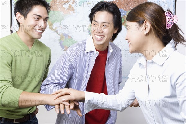 Portrait of young businesspeople in huddle