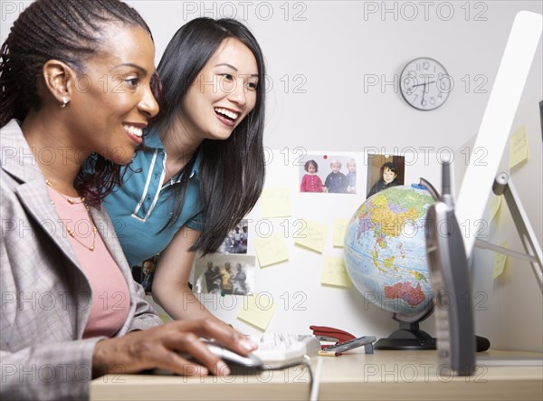 Two businesswomen looking at computer