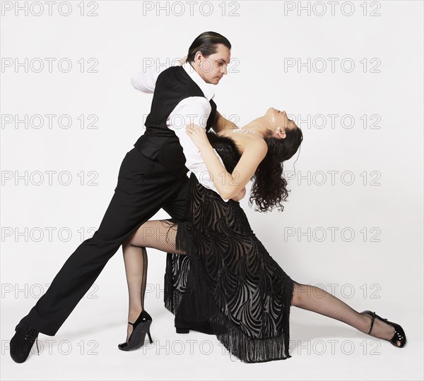 Multi-ethnic couple tango dancing