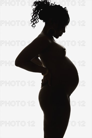 Silhouette of pregnant nude African American woman