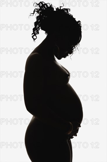 Silhouette of pregnant nude African American woman