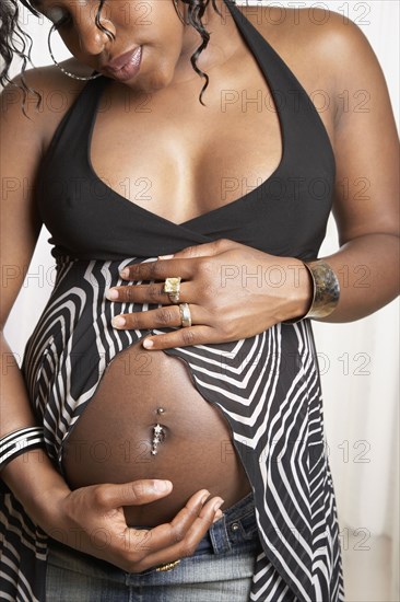 Pregnant African American woman with hands on belly