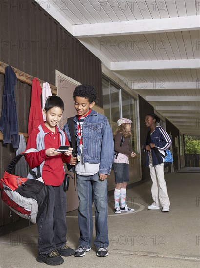 Multi-ethnic school children outside building