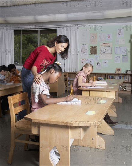 Indian female teacher helping student