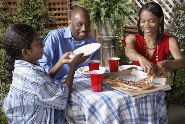 African family eating pizza