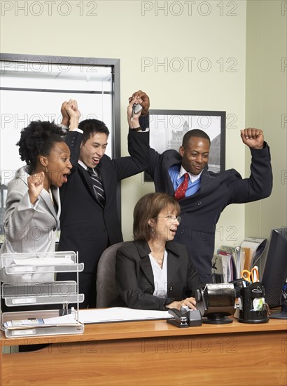 Multi-ethnic businesspeople cheering