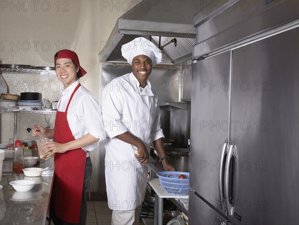 Multi-ethnic male chefs preparing food