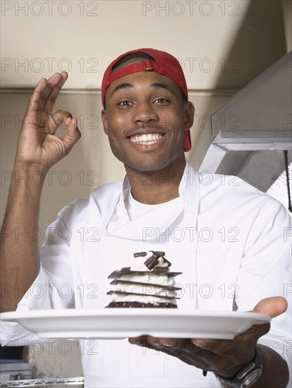 African American male chef holding desert