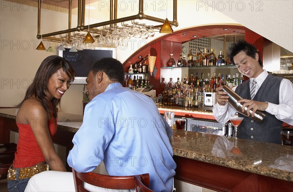 African American couple sitting at bar