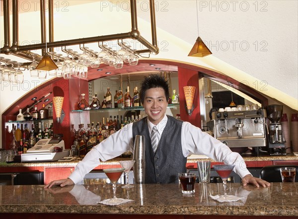 Asian male bartender and cocktails