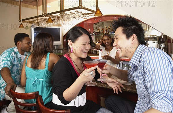 Multi-ethnic people sitting at bar