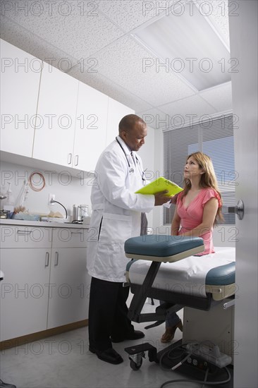 African American male doctor talking to patient