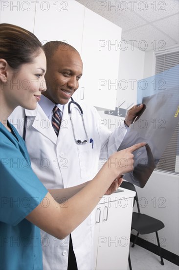 Multi-ethnic medical professionals looking at x-rays