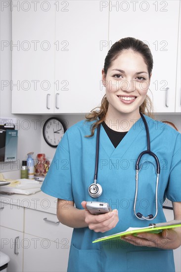 Hispanic female medical professional holding chart