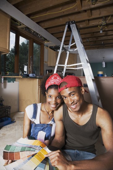 African American couple looking at paint swatches