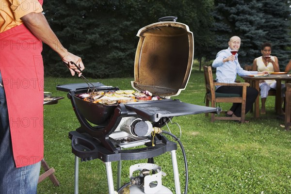 Multi-ethnic friends having barbecue